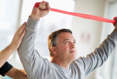 Man using elastic band to exercise.