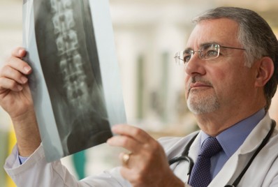 Doctor looking at image of spine.